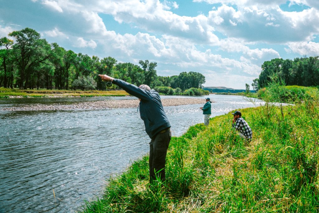 People fishing on river bank