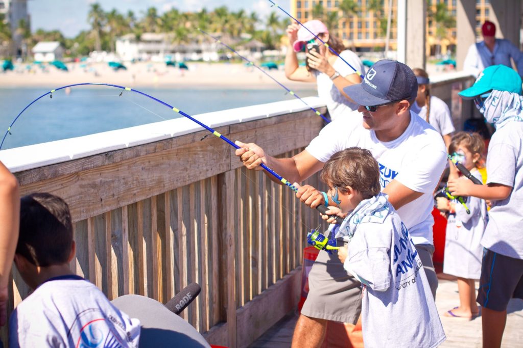 Boy and man fishing from dock