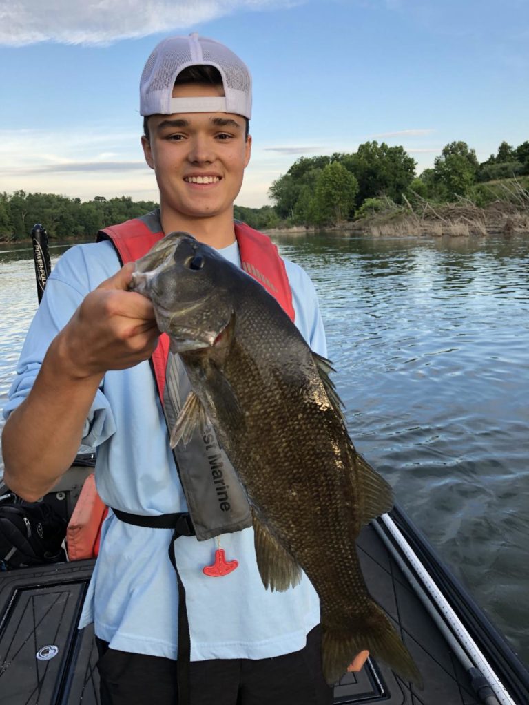 Young man holding fish